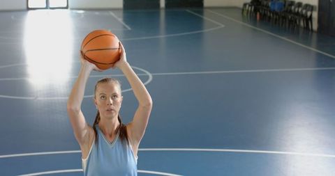Female Basketball Player Prepares Free Throw on Indoor Court