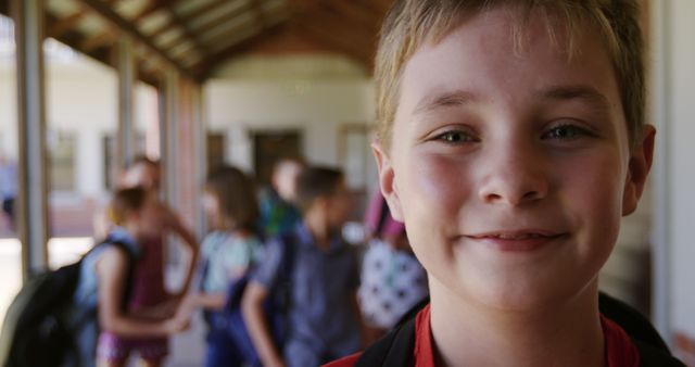 Happy Child Smiling at School Hallway with Friends in Background - Download Free Stock Images Pikwizard.com