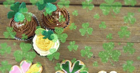 Festive St. Patrick's Day Cupcakes and Shamrocks on Rustic Wooden Table