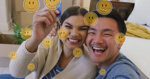 Joyful biracial couple celebrating new home with house key