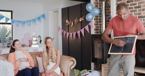 Diverse Friends Enjoying Games at Baby Shower Celebration