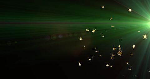 Golden Stars and Green Light Trails on Black Background
