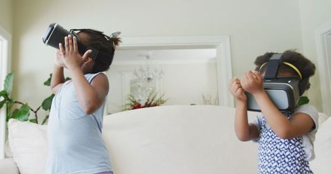 African American Girls Immersed in Virtual Reality at Home