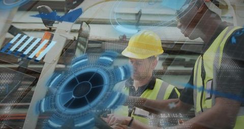 Factory workers reviewing tablet with ar data overlay for smart manufacturing collaboration