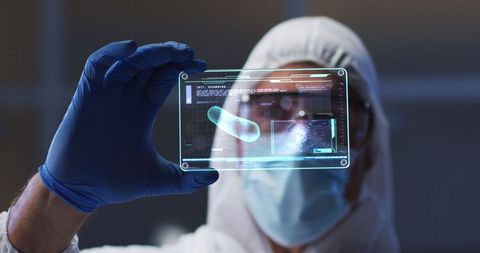 Scientist Analyzing Interactive Medical Data on Transparent Screen