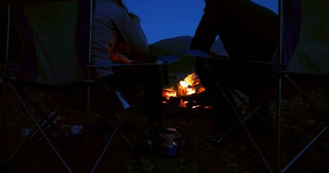 Cozy Outdoor Camping Experience by Fire at Dusk