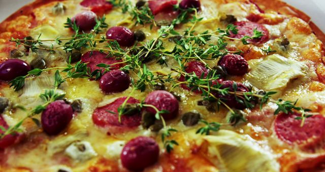 Gourmet pizza covered with slices of artichoke, salami, capers, melting cheese, and fresh herbs. Ideal for use in food blogs, restaurant menus, culinary magazines, and promotional material for pizzeria establishments highlighting specialty toppings and fresh ingredients.