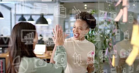 Diverse businesswomen collaborating in high-tech office