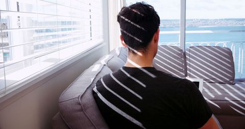 Contemplative man relaxing with scenic coastal view