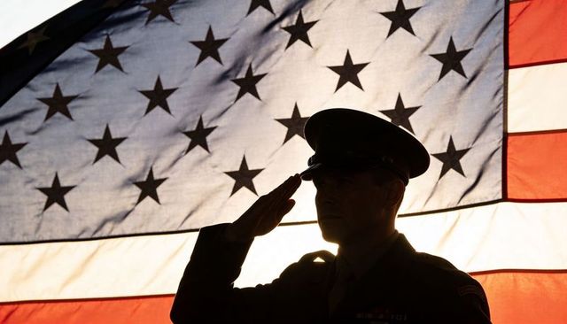 Saluting soldier silhouette against backlit american flag during military ceremony
