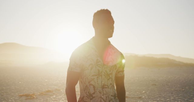 Smiling Young Man Walking on Beach During Sunset - Download Free Stock Images Pikwizard.com