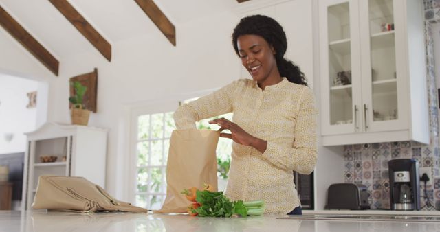 African American Woman Unpacking Groceries in Kitchen - Download Free Stock Images Pikwizard.com