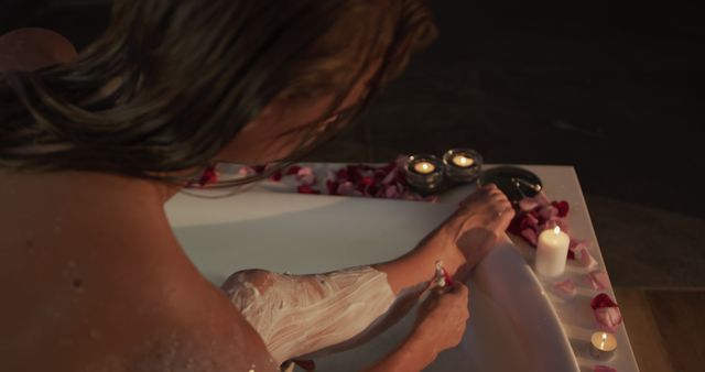 Woman Shaving Legs in Candlelit Bath with Rose Petals - Download Free Stock Images Pikwizard.com