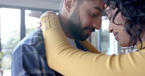 Affectionate Biracial Couple Sharing Tender Moment at Home