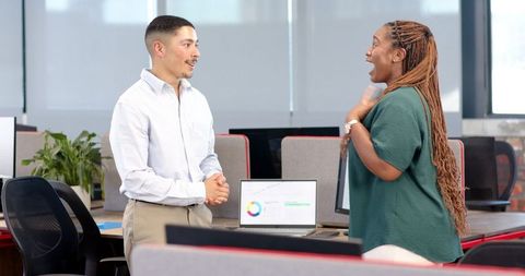 Cheerful Coworkers Celebrating Success in Modern Office Environment