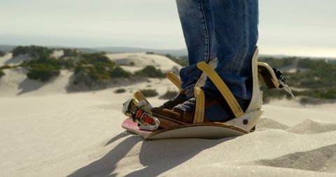 Close-up of sandboarding in a desert adventure