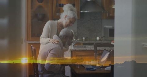 Elderly Couple Collaborating in Kitchen with Laptop