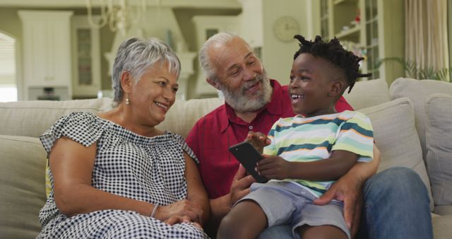 Grandparents Bonding with Grandson While Using Smartphone at Home - Download Free Stock Images Pikwizard.com