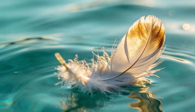Sunlit feather drifting on turquoise water with soft ripples and golden bokeh