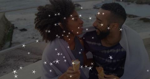 Romantic couple enjoying coastal ice cream together