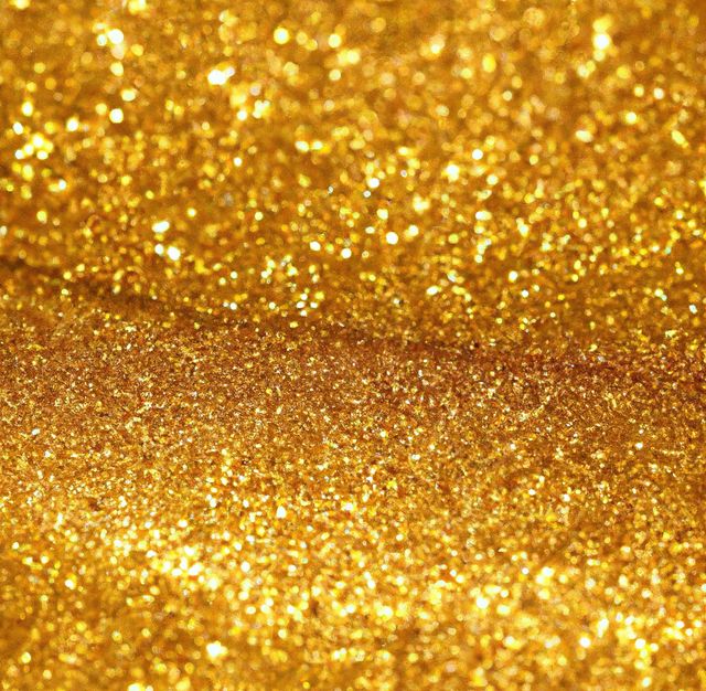 Image of close up of gold glitter particles background with copy space. Glitter, make up, colour and glamour concept.