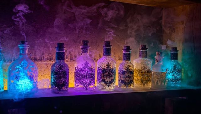 Mystical glowing bottles with smoke on rustic shelf