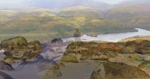 Senior Hiker Overlooking Tranquil Inlet at Rocky Shoreline