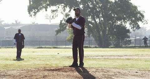 Men playing baseball at neighborhood park outdoor game
