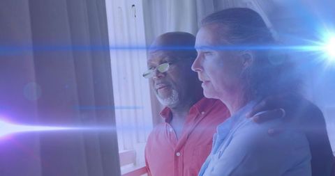 Elderly Couple Enjoying Serene Moment with Lens Flare