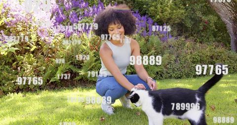 Woman petting black and white cat on sunlit lawn with violet garden and numeric overlay