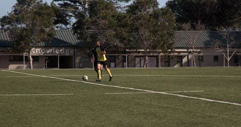 Teen soccer player on field practicing strategies