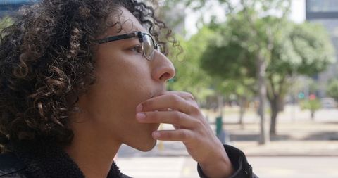 Young Man Whistling for Taxi on Bright Urban Street