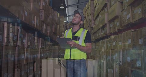 Worker Analyzing Global Data in Busy Warehouse - Download Free Stock Images Pikwizard.com