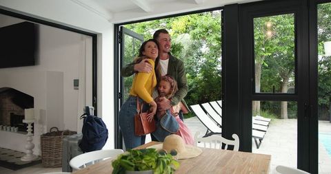 Happy Family Reuniting at Home After Summer Vacation