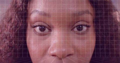 Close-up biometric facial scanning with tech grid overlay