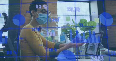 Masked Professional Analyzing Digital Data in Modern Workspace