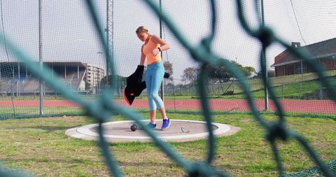 Athlete preparing for shot put at outdoor track field
