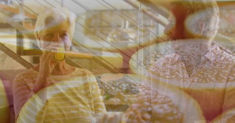 Senior Couple Enjoying Orange Juice with Citrus Overlay