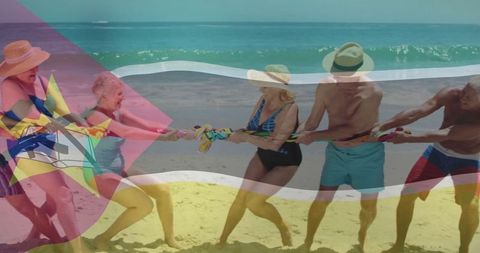 Group of Senior Friends Enjoying a Lively Tug-of-War on Beach Vacation