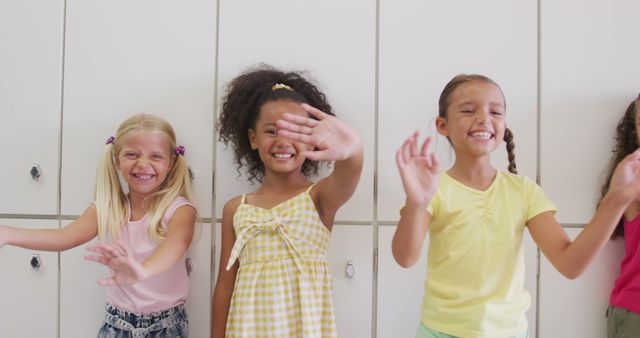 Group of happy and diverse children waving and smiling in a classroom, expressing joy and friendship. Perfect for use in advertisements related to school, education, diversity initiatives, childhood, and joyous activities. Ideal for promoting classroom harmony, multicultural education programs, and child-friendly products.