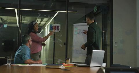 Team Analyzing Charts in Modern Conference Room Setting