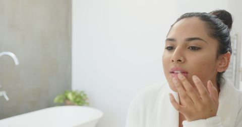 Indian Woman in Minimalist Bathroom Practicing Skincare Ritual