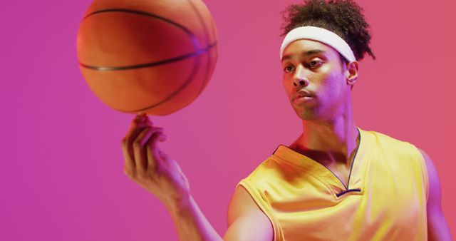 Focused Basketball Player Spinning Ball on Finger in Neon Lighting - Download Free Stock Images Pikwizard.com