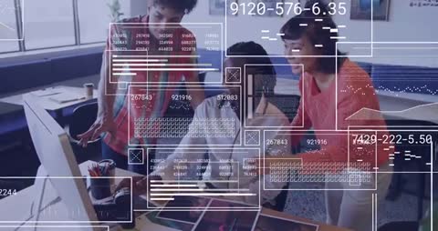 Creative Team Analyzing Data Streams on Desktop in Modern Office