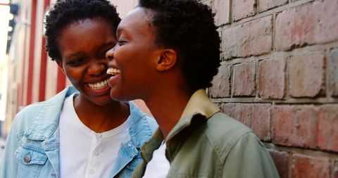 Happy Twin Sisters Laughing Together in Urban Street Atmosphere - Download Free Stock Images Pikwizard.com