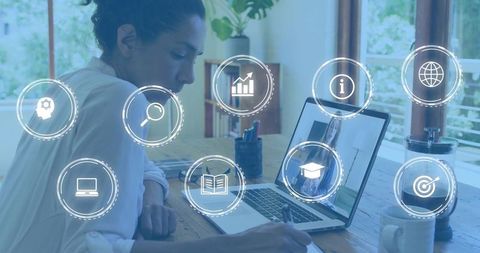 Woman taking notes during online learning at home with laptop and education icons