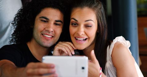 Excited Couple Enjoying Content on Smartphone Together