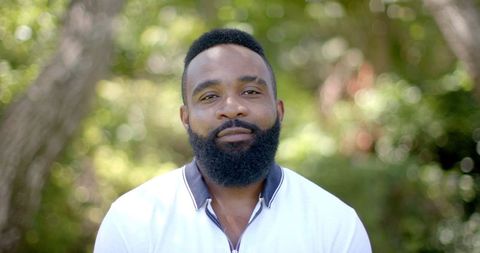 Smiling African American Man in Lush Garden Setting
