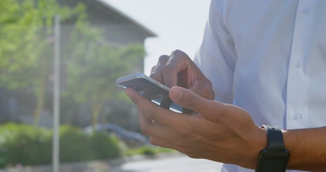 Hands Holding Smartphone in Sunny Outdoor Urban Area - Download Free Stock Images Pikwizard.com