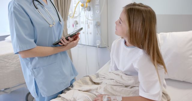 Nurse consulting with young patient in hospital bed - Download Free Stock Images Pikwizard.com